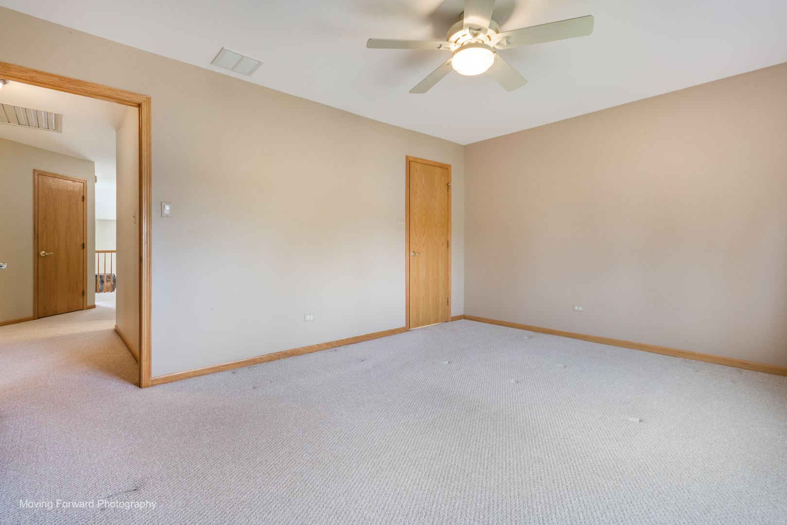 14825 Steven Court Lemont, IL 60439 - Photo 4 of 50 an empty room with a chandelier fan and a bathroom