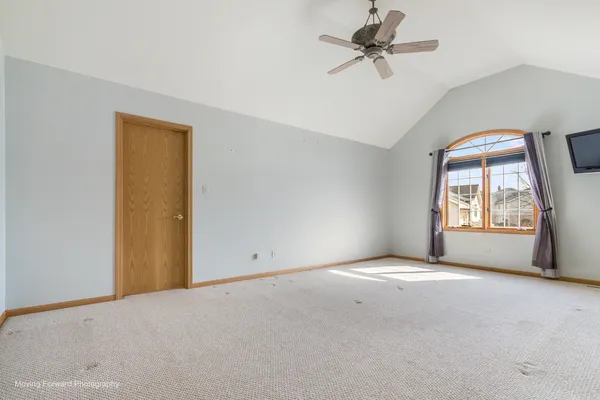 a view of a livingroom with a ceiling fan and window