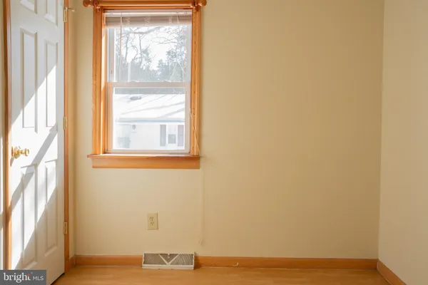 a view of a room with wooden floor and windows