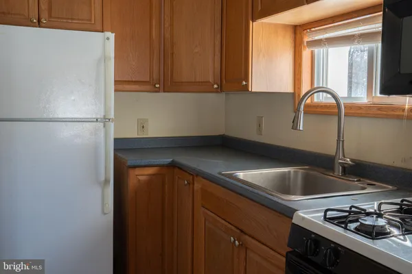 a kitchen with a sink and a refrigerator