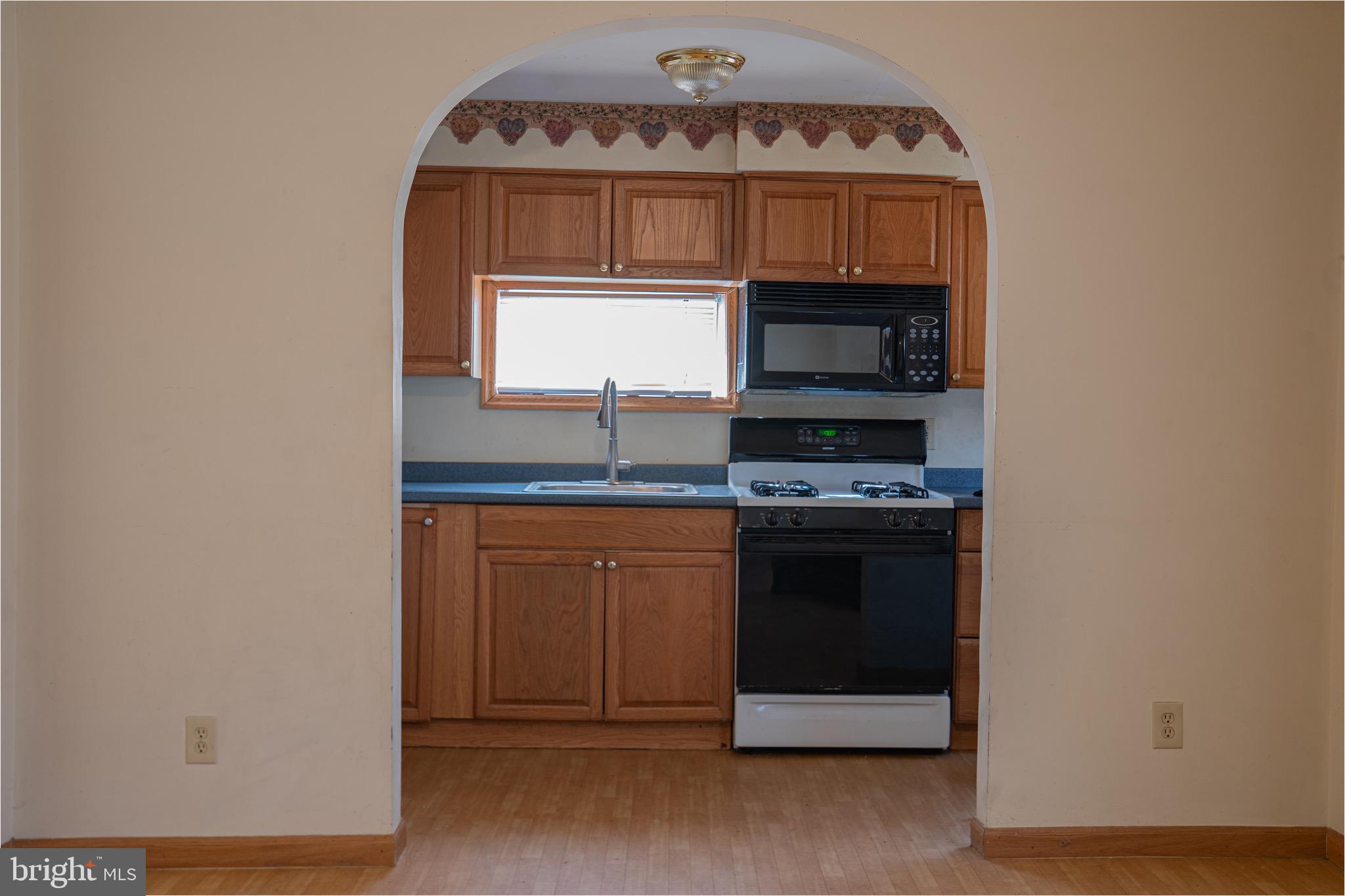 1452 Coles Mill Road Franklinville, NJ 08322 - Photo 8 of 8 a kitchen with a stove and a microwave