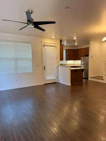 a view of kitchen and hall with wooden floor