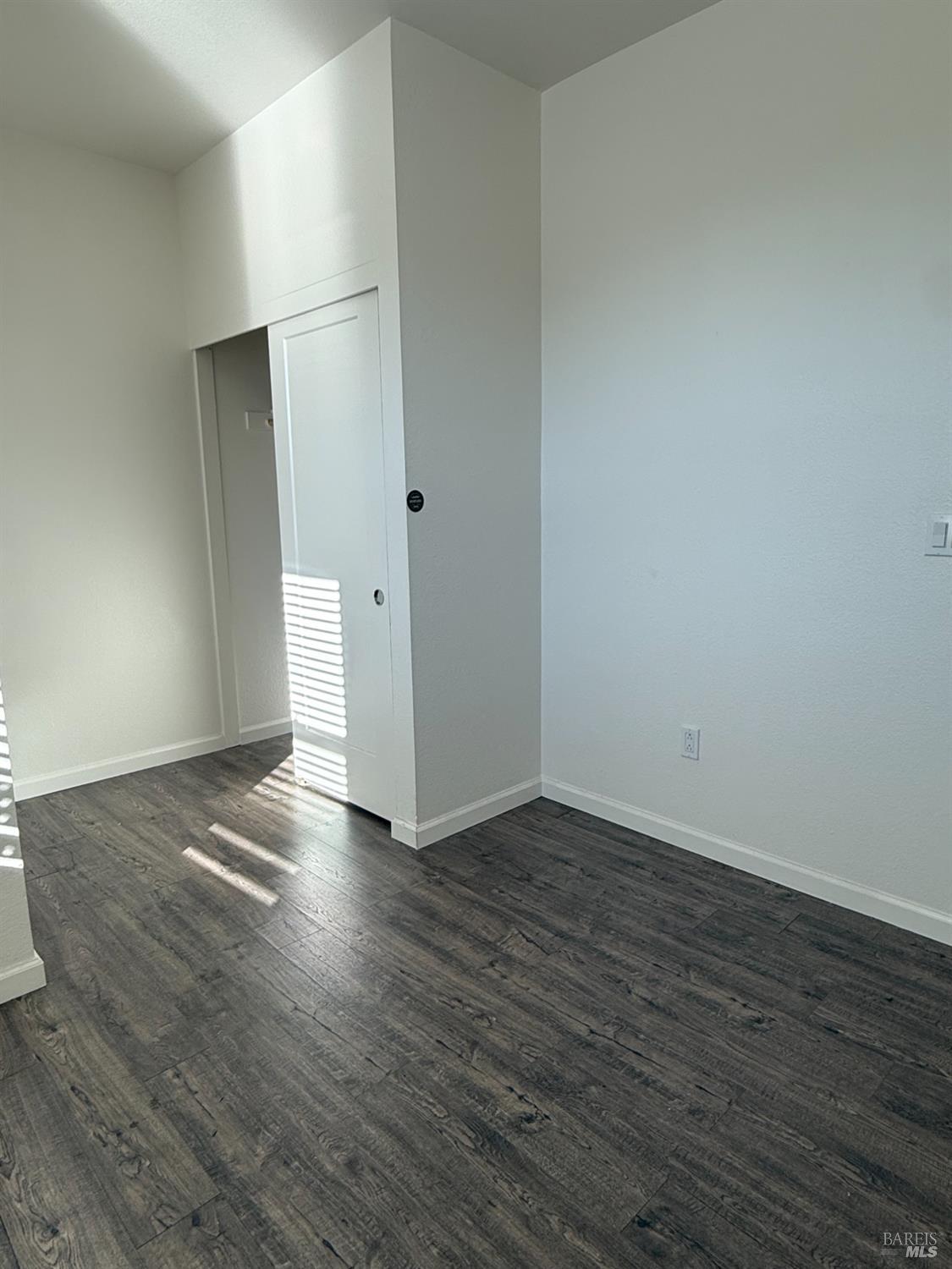 524 Blythewood Place Santa Rosa, CA 95407 - Photo 12 of 21 a view of an empty room with wooden floor and a window