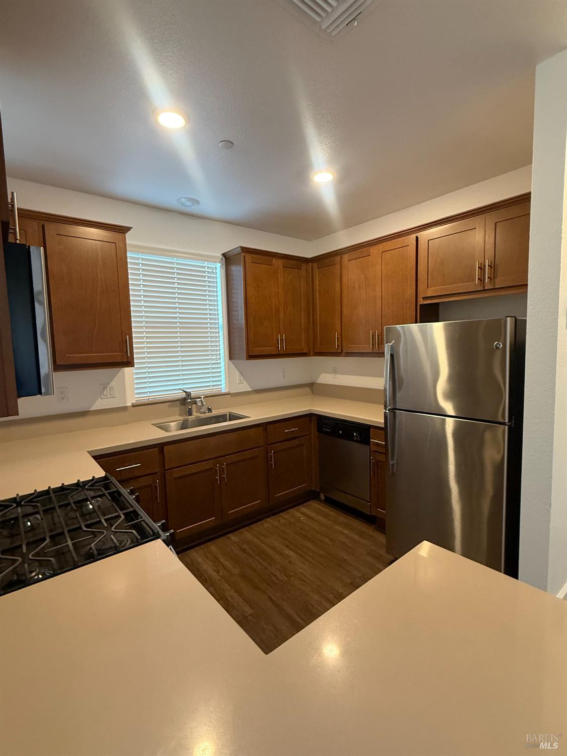 524 Blythewood Place Santa Rosa, CA 95407 - Photo 6 of 21 a kitchen with a refrigerator sink and wooden cabinets
