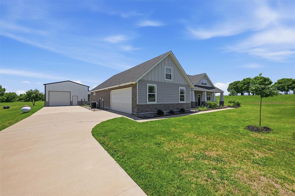 662 Preakness Place Road Van Alstyne, TX 75495 - Photo 3 of 39 a front view of a house with a yard