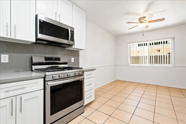 a kitchen with a stove a microwave and cabinets