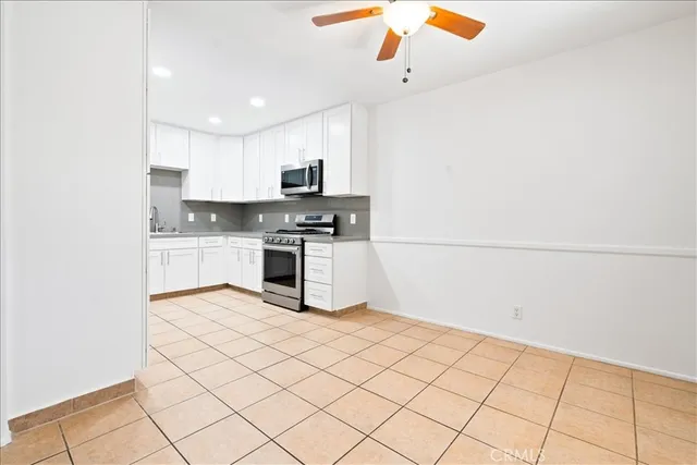 a kitchen with stainless steel appliances a refrigerator sink and microwave