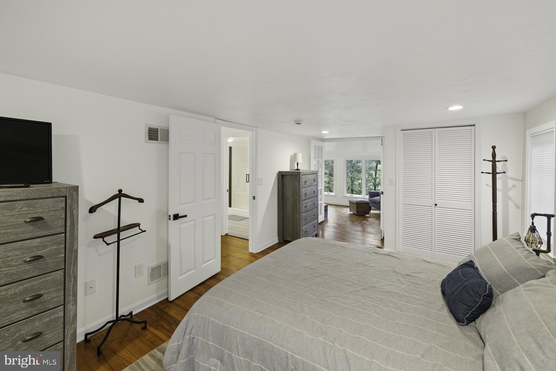 229 Boy Scout Road New Oxford, PA 17350 - Photo 19 of 73 a bedroom with a bed and a flat screen tv