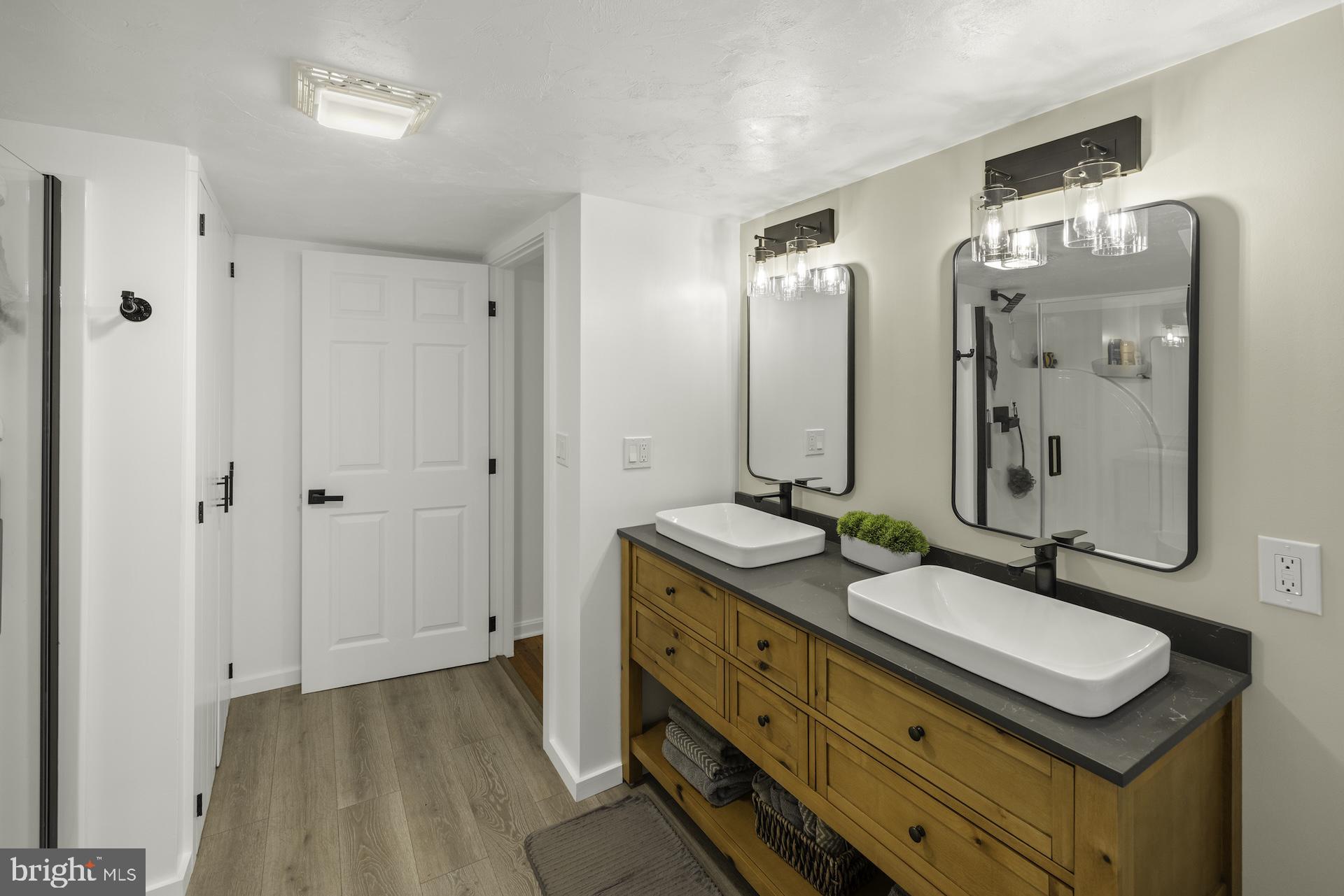 229 Boy Scout Road New Oxford, PA 17350 - Photo 26 of 73 a bathroom with a double vanity sink and a mirror