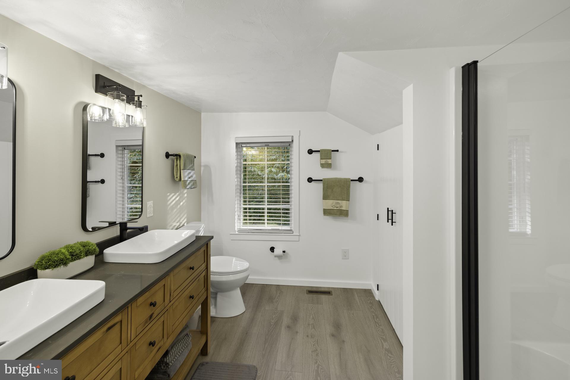 229 Boy Scout Road New Oxford, PA 17350 - Photo 27 of 73 a bathroom with a granite countertop sink a toilet a mirror and shower