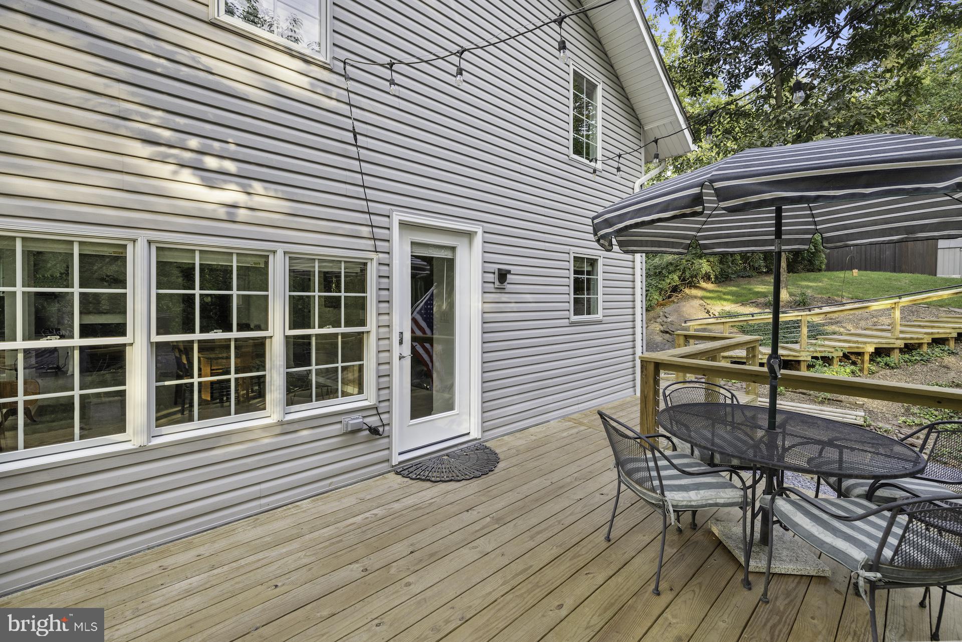 229 Boy Scout Road New Oxford, PA 17350 - Photo 31 of 73 a view of a deck with a table and chairs next to a yard