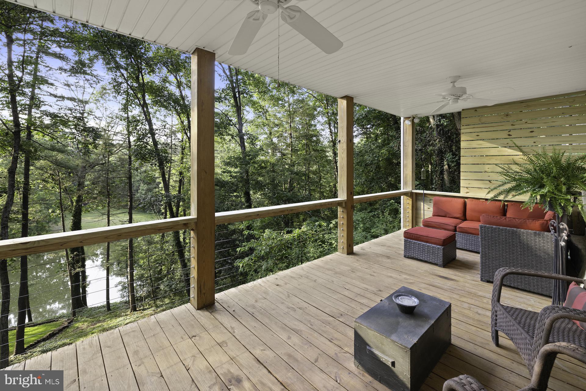 229 Boy Scout Road New Oxford, PA 17350 - Photo 35 of 73 a view of a balcony with chairs and wooden floor