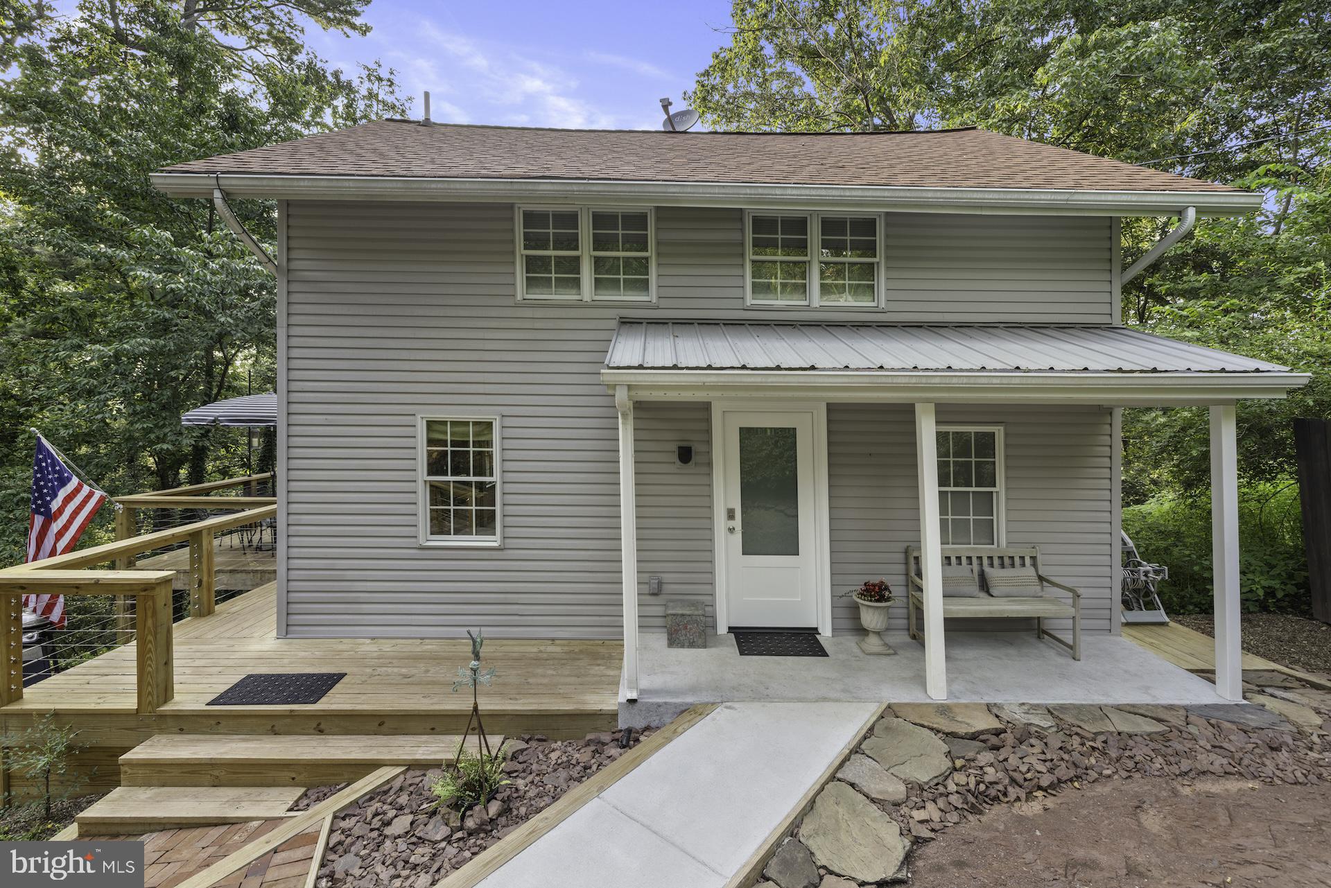 229 Boy Scout Road New Oxford, PA 17350 - Photo 39 of 73 a view of a house with a chairs and table in a patio