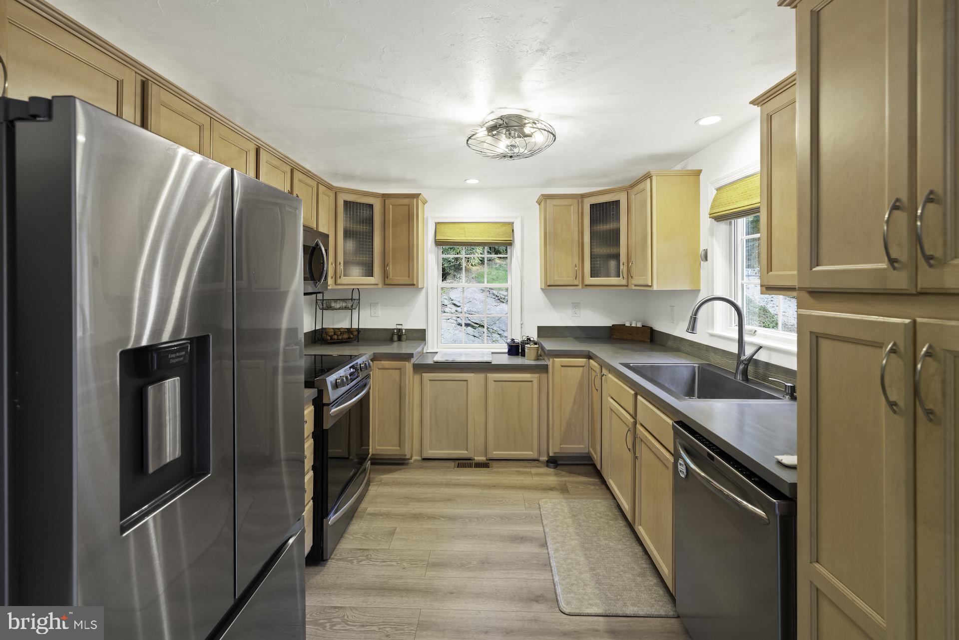 229 Boy Scout Road New Oxford, PA 17350 - Photo 7 of 73 a kitchen with granite countertop a refrigerator stove and sink