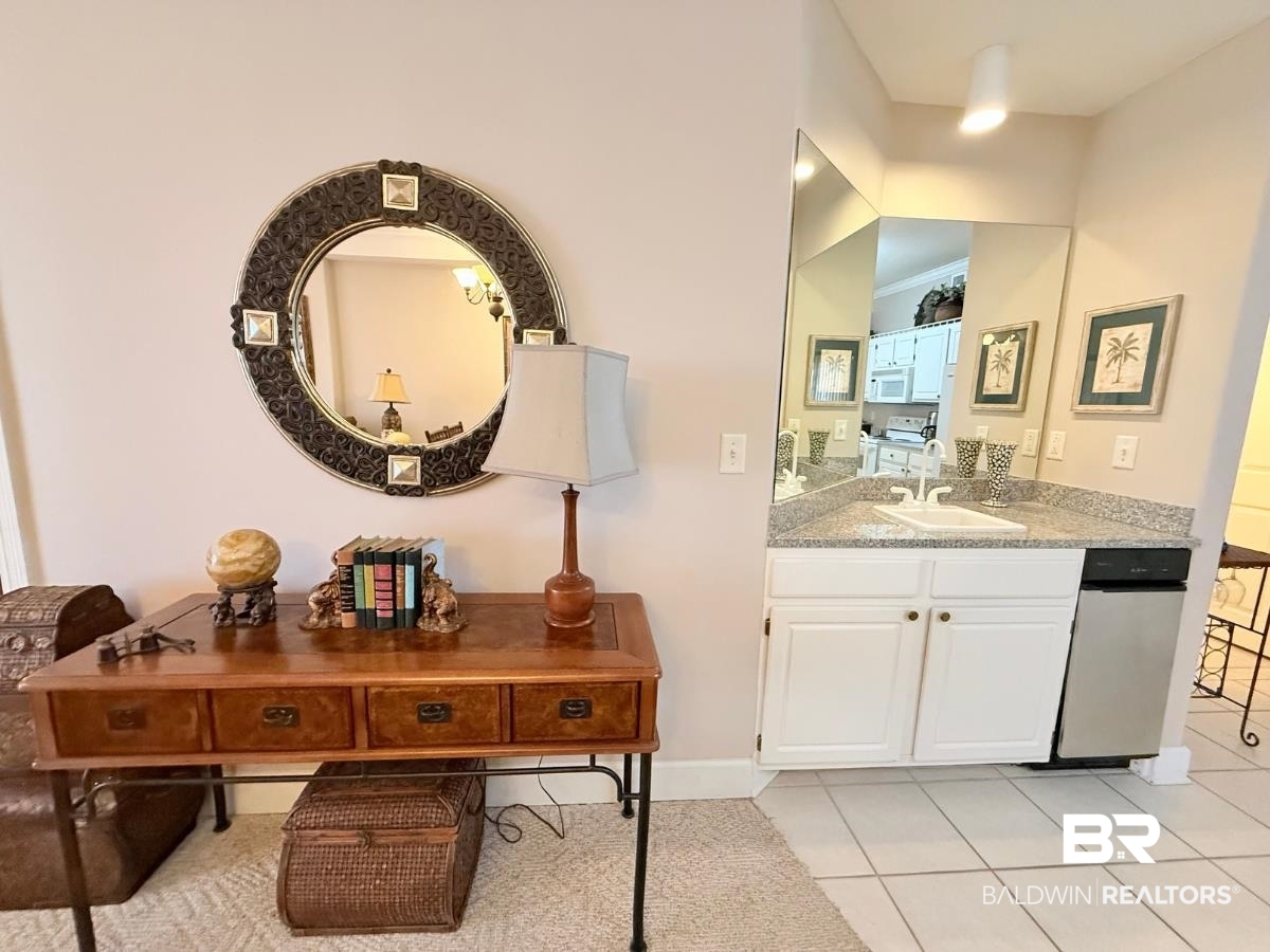 27284 Gulf Road, Unit 212 Orange Beach, AL 36561 - Photo 10 of 35 Bathroom featuring vanity, light tile patterned floors, and ornamental molding