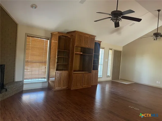 a kitchen with granite countertop a sink stove and refrigerator