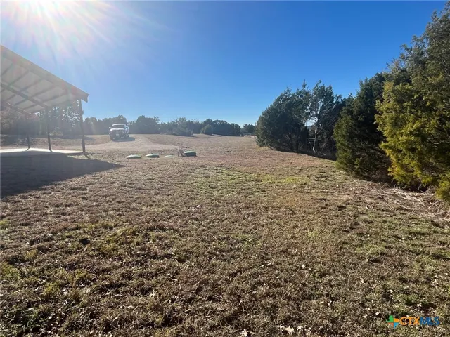 a view of a livingroom with a chair and a ceiling fan