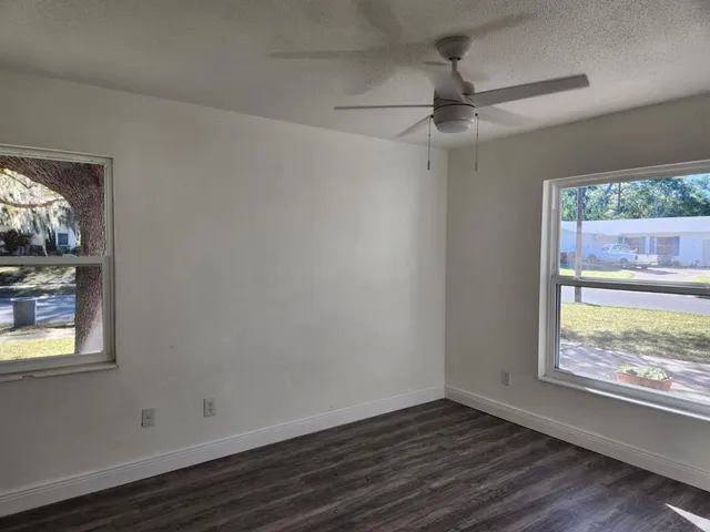 a view of room with window and wooden floor