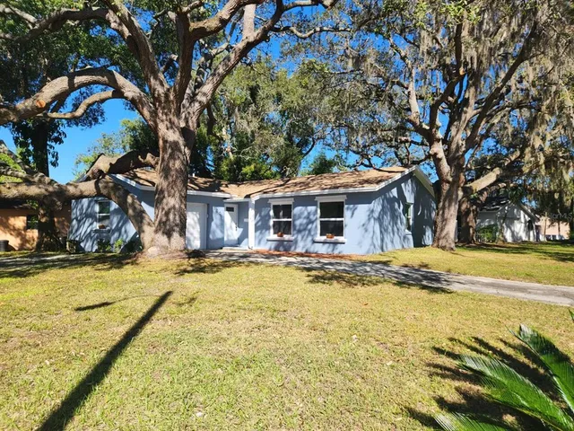 a front view of house with yard and swimming pool
