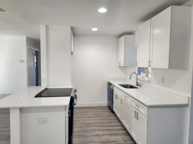 a kitchen with a sink and a refrigerator