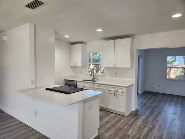 a kitchen with a sink stove and cabinets