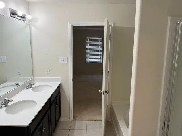 a bathroom with a sink vanity and mirror