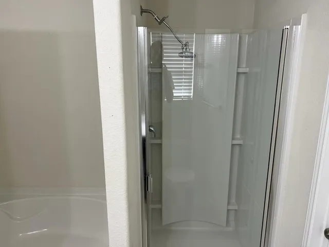 a bathroom with a shower and a tub