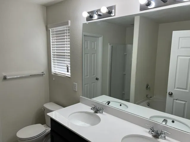 a bathroom with a sink toilet and mirror