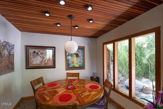 a bedroom with a bed a large window with the outer view