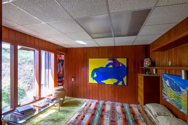 a bedroom with natural light and a window