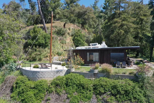 a backyard of a house with a yard and outdoor seating