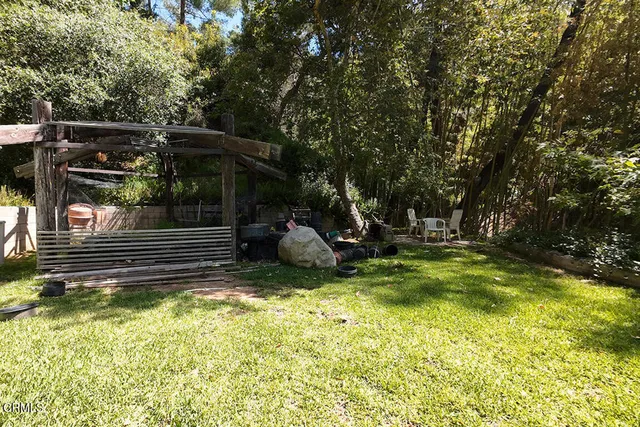 a view of a backyard with a small cabin and furniture