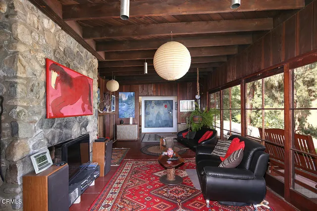 a living room with furniture a fireplace and a large window