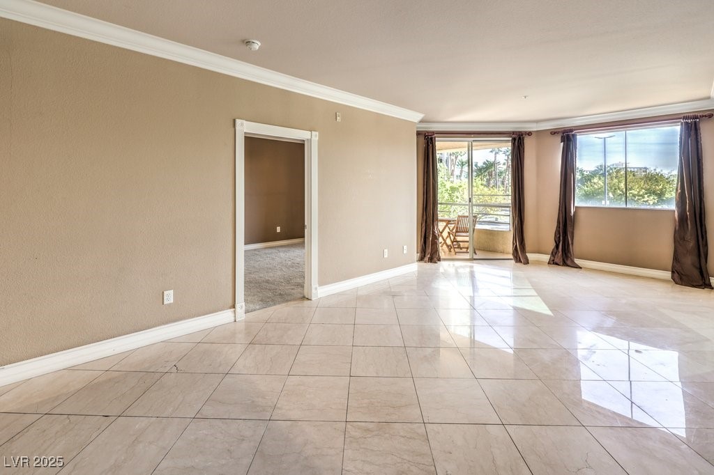 270 East Flamingo Road, Unit 115 Las Vegas, NV 89169 - Photo 13 of 29 Spare room with crown molding and light tile patterned flooring