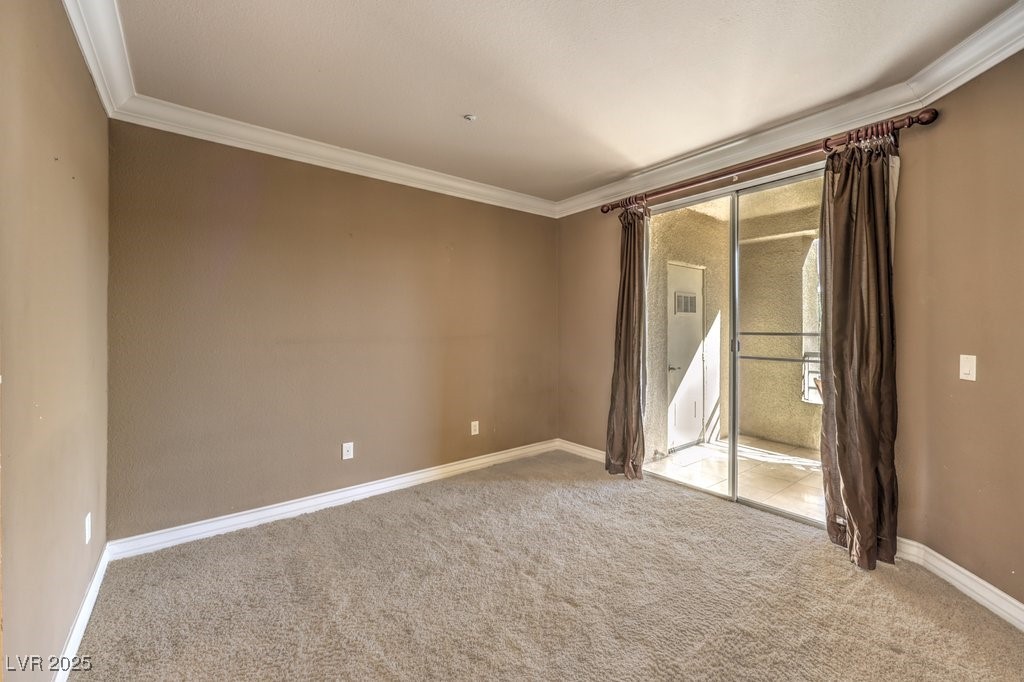 270 East Flamingo Road, Unit 115 Las Vegas, NV 89169 - Photo 15 of 29 Carpeted spare room with ornamental molding