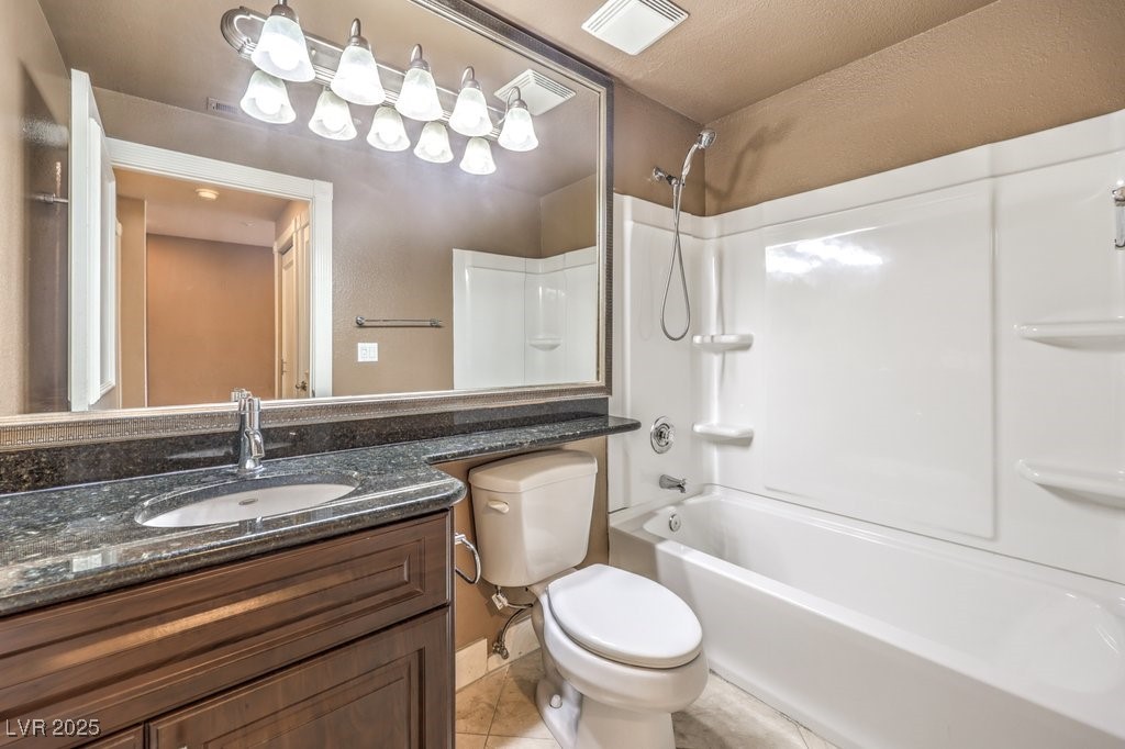 270 East Flamingo Road, Unit 115 Las Vegas, NV 89169 - Photo 22 of 29 Bathroom with washtub / shower combination, vanity, and tile patterned flooring