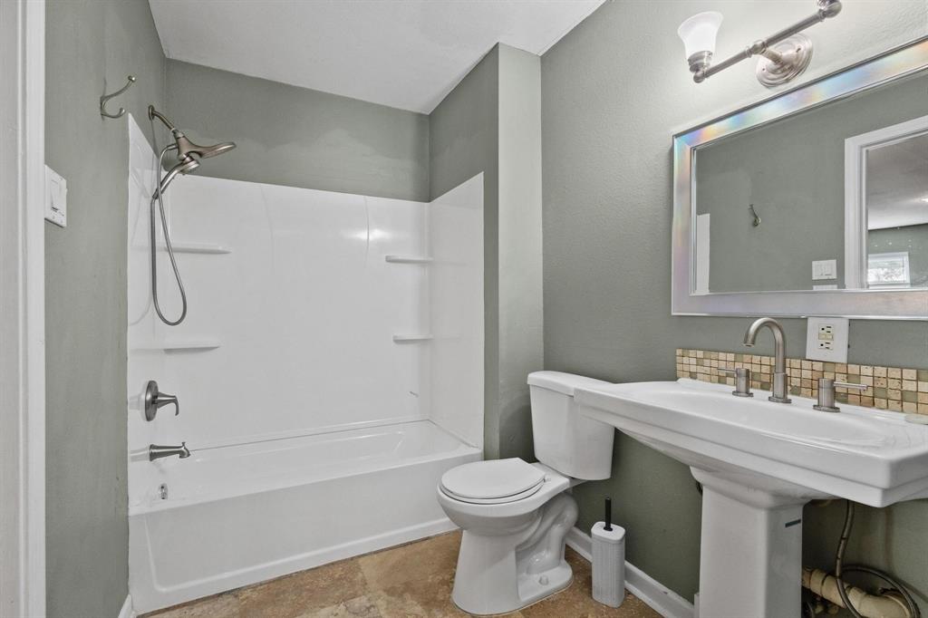 1704 West Birge Street Sherman, TX 75092 - Photo 13 of 23 a bathroom with a sink toilet and shower
