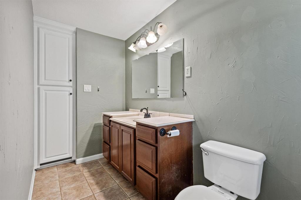 1704 West Birge Street Sherman, TX 75092 - Photo 18 of 23 a bathroom with a sink and a mirror
