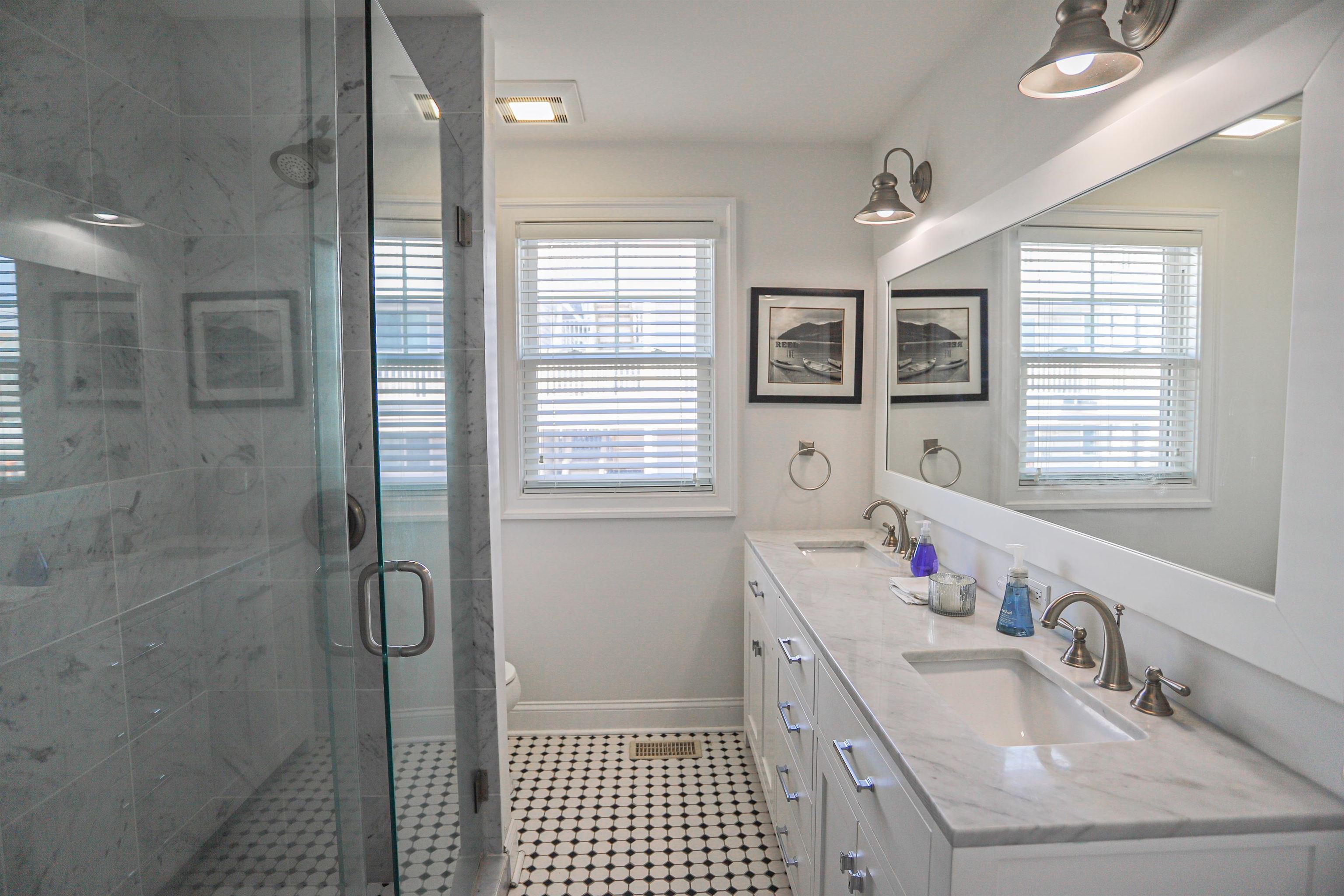 285 78th Street Avalon, NJ 08202 - Photo 24 of 48 a bathroom with a sink mirror and a shower