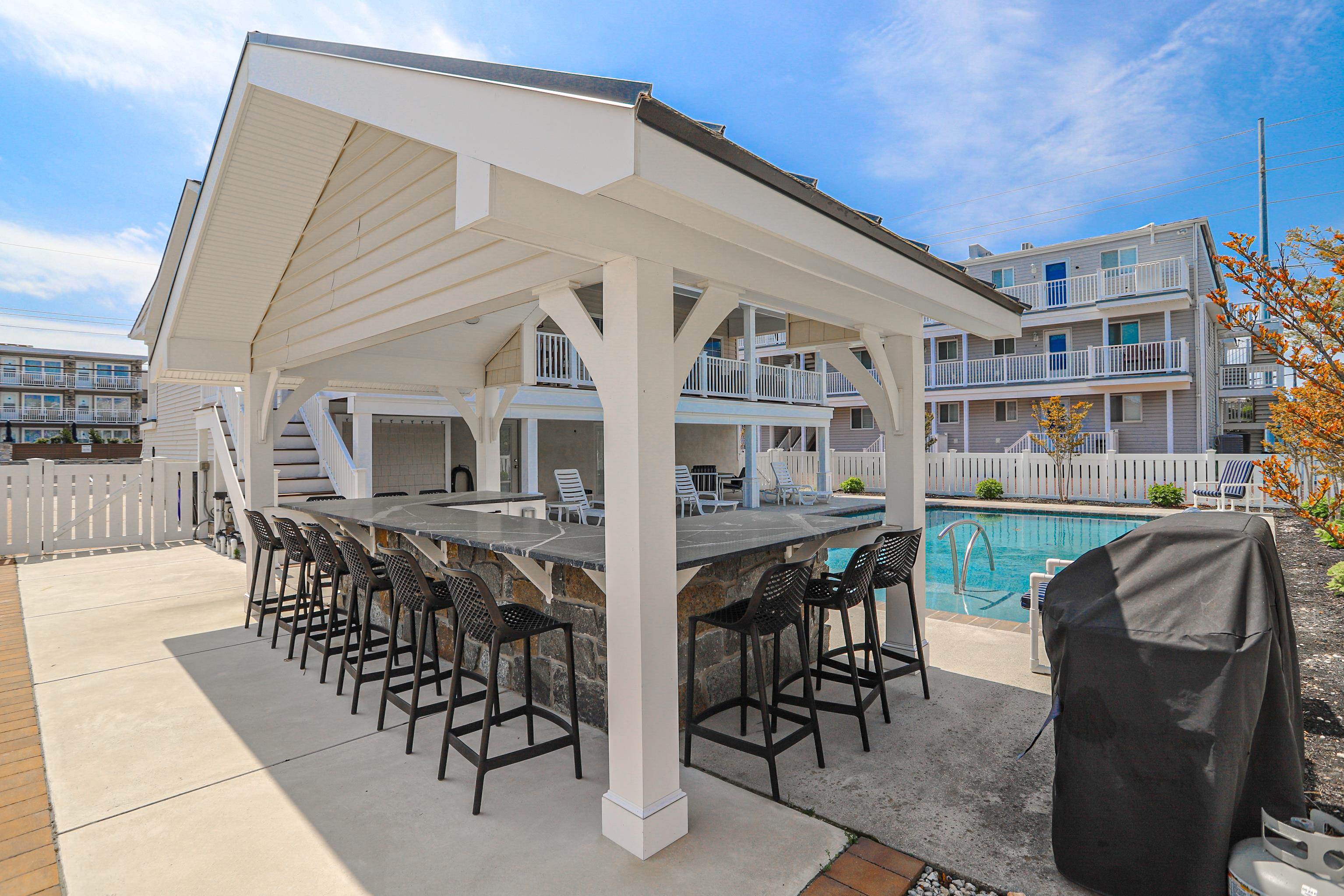 285 78th Street Avalon, NJ 08202 - Photo 45 of 48 a view of a patio with table and chairs with wooden floor and fence