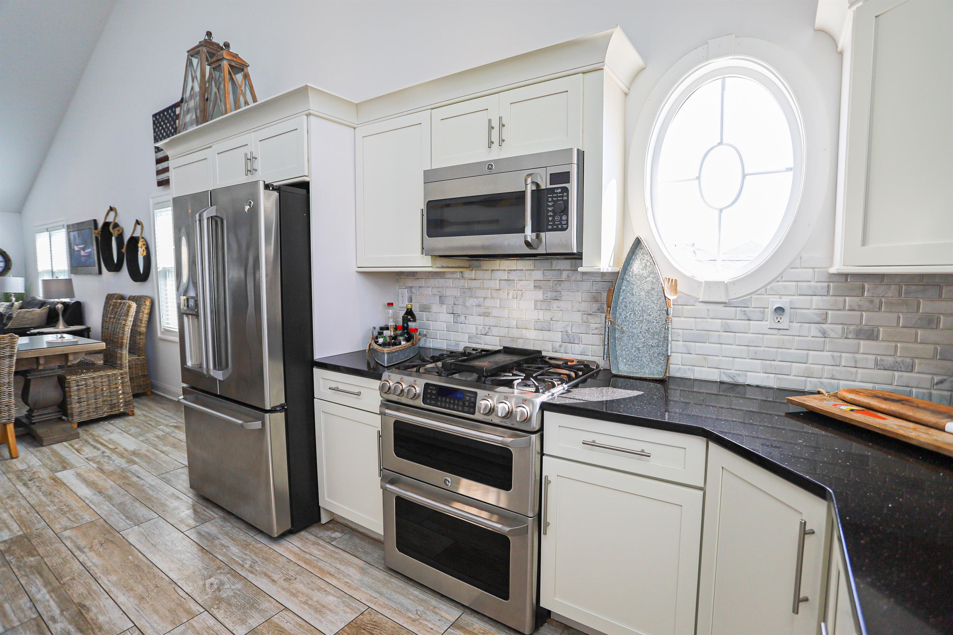 285 78th Street Avalon, NJ 08202 - Photo 10 of 48 a kitchen with stainless steel appliances granite countertop a stove microwave and a refrigerator