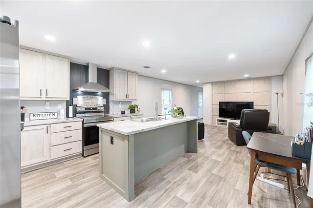 a kitchen with stainless steel appliances a sink stove and cabinets