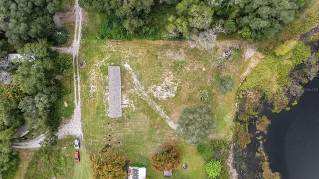 an aerial view of a houses with a yard