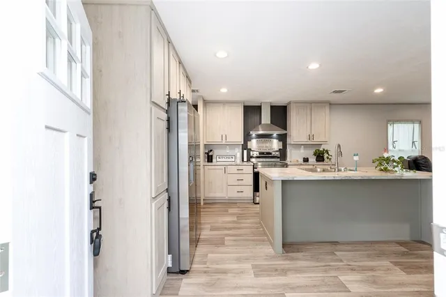 a kitchen with a sink stove and wooden cabinets