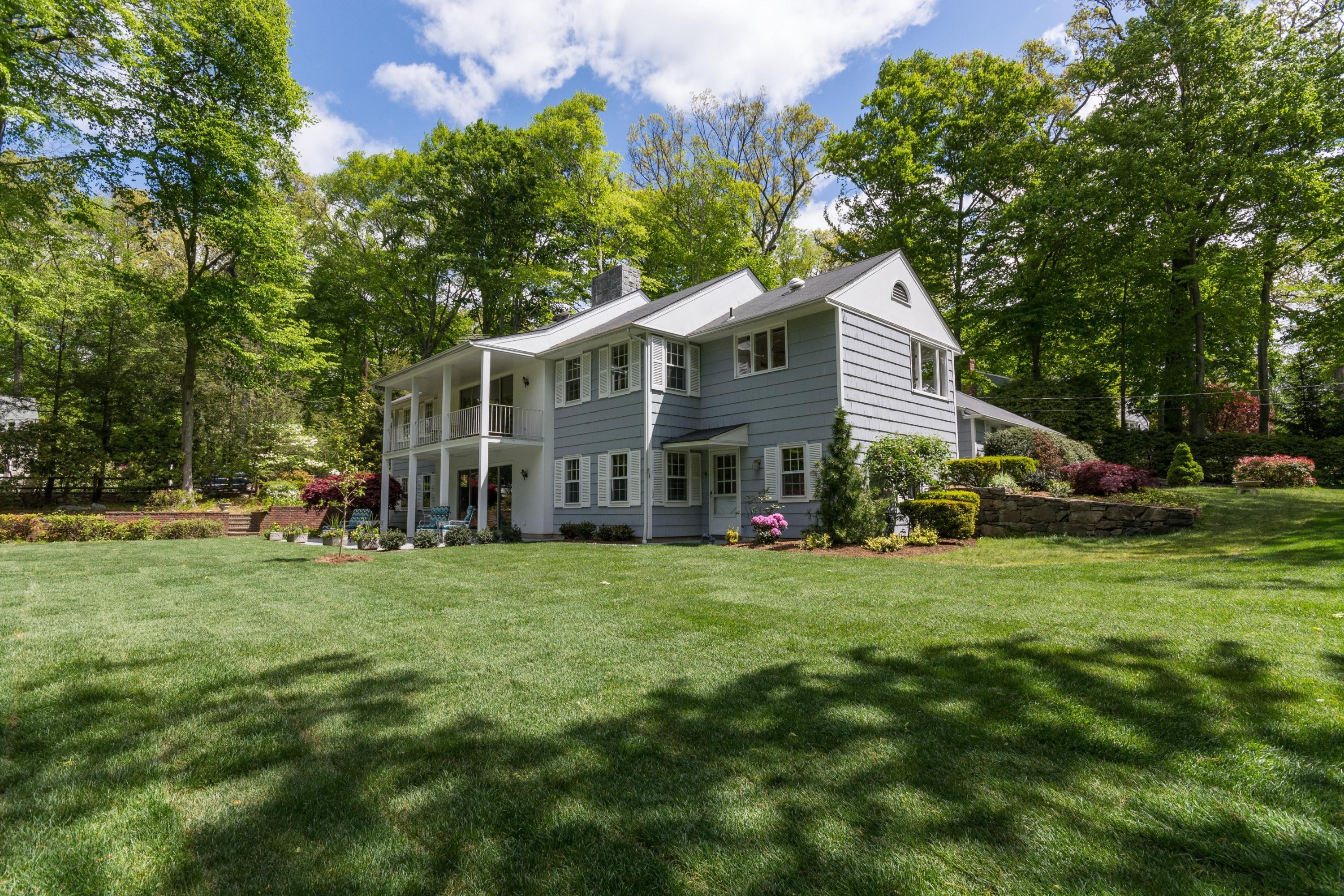 145 Middlesex Road Darien, CT 06820 - Photo 1 of 23 a view of a house with a big yard and large trees
