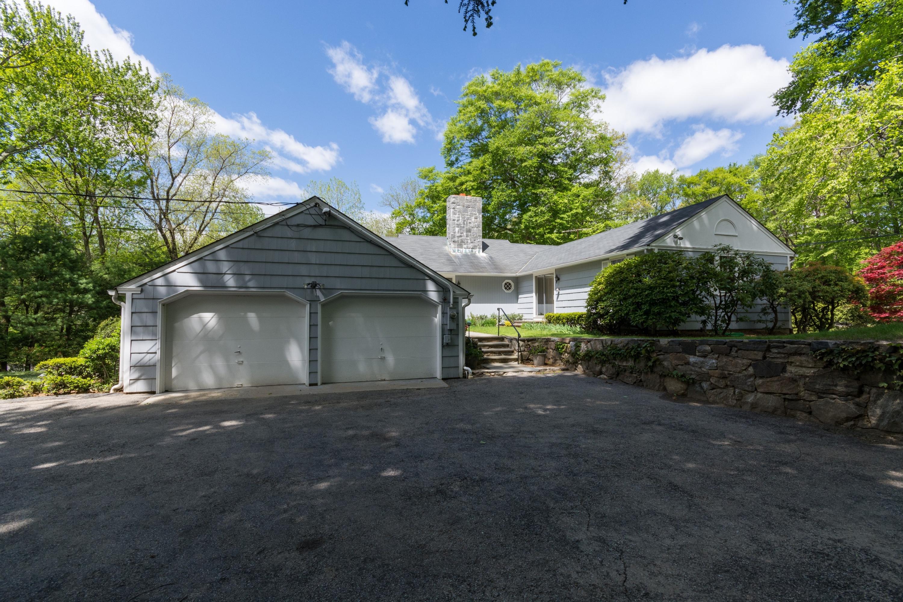 145 Middlesex Road Darien, CT 06820 - Photo 2 of 23 a front view of a house with a yard and garage