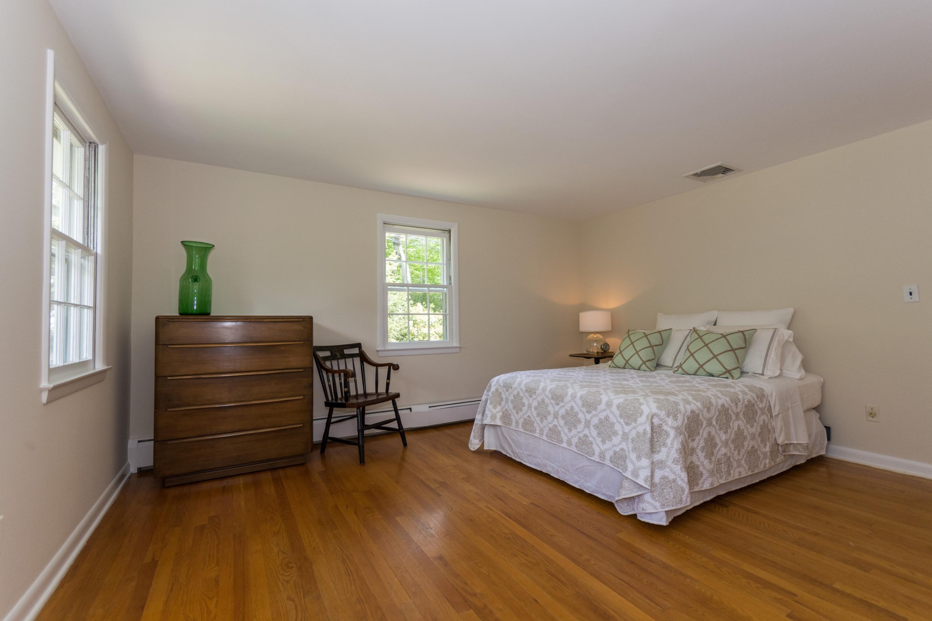 145 Middlesex Road Darien, CT 06820 - Photo 11 of 23 a bedroom with a bed and a window