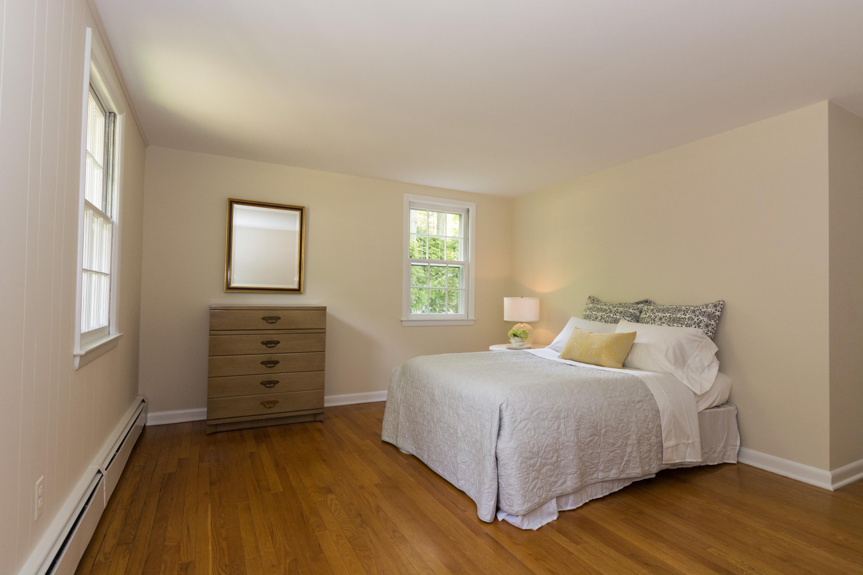 145 Middlesex Road Darien, CT 06820 - Photo 14 of 23 a bedroom with a bed and a closet