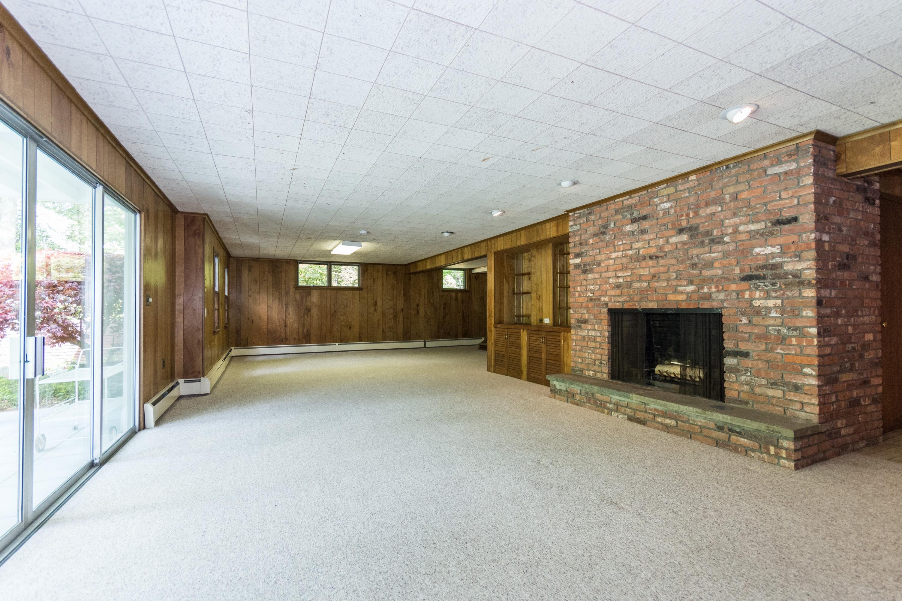 145 Middlesex Road Darien, CT 06820 - Photo 16 of 23 a view of an empty room with a fireplace