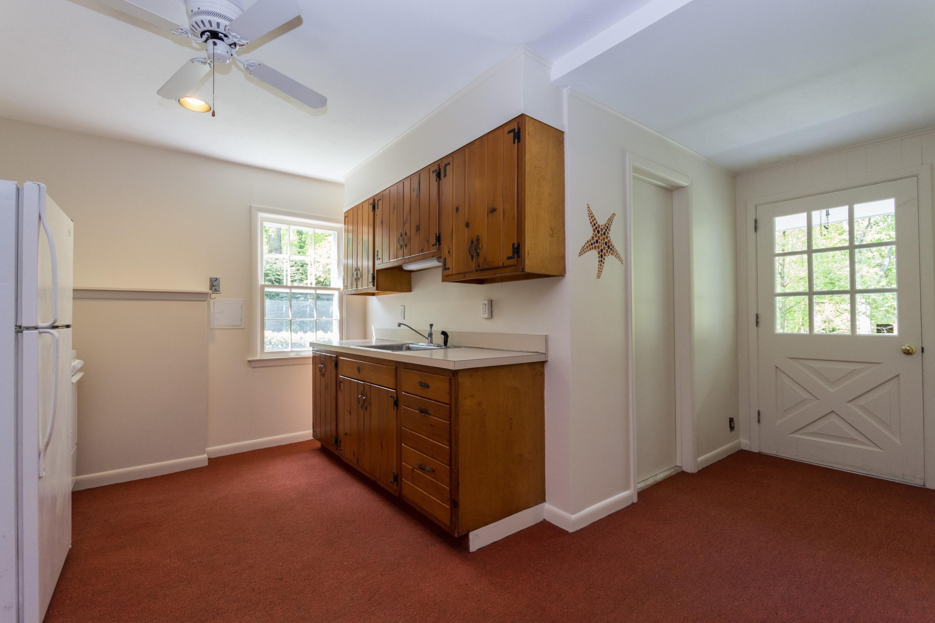 145 Middlesex Road Darien, CT 06820 - Photo 17 of 23 a kitchen with sink cabinets and window